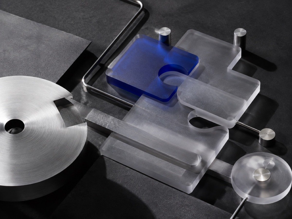 Translucent cobalt and metal forms representing connected AI systems